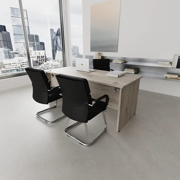 visitor chair in black leather and chrome cantilever frame at office desk