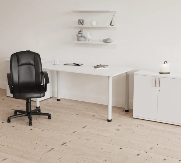 black leather office chair in front of white office desk room shot