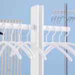 white coat hanger on coat stand