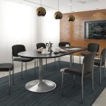 Stackable conference chairs in black fabric with no arms around a meeting table.