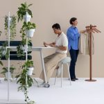 contemporary coat stand in brown in office with people working