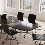 design classic high back office chair in black leather and chrome frame. In room set around meeting table