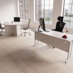 design classic high back office chair in black leather and chrome frame. In room shot with office desk and round meeting table