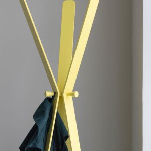 designer coat stand in yellow with coat hanging on it