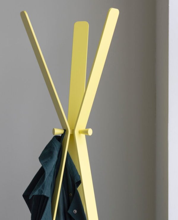 designer coat stand in yellow with coat hanging on it