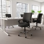 ergonomic operators chair in black fabric in office with white desks