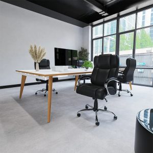 heavy duty office chair in black leather in front of office desk