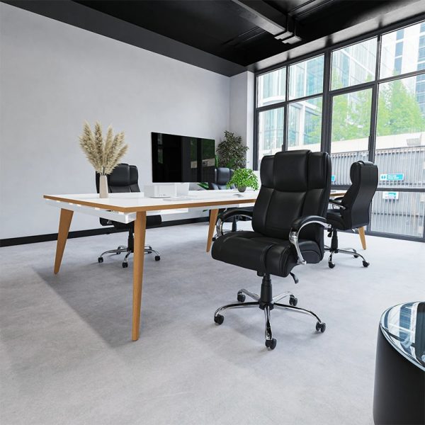 heavy duty office chair in black leather in front of office desk