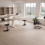 height adjustable sit stand desks room shot with light desk tops and white leg frame. City view out of window