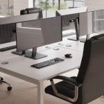 black leather executive chair in office room shot by office desks