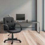 black leather executive chair in office with office desk in background