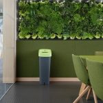 office recycling bin with grey body and green lid in office