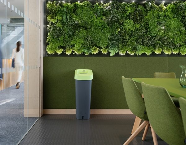 office recycling bin with grey body and green lid in office