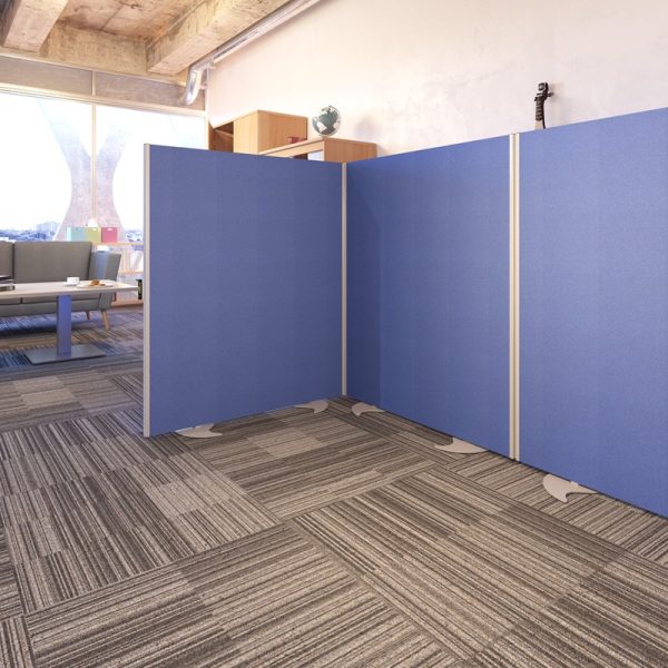office screen in blue fabric floor standing. IN reception area with grey sofa and coffee table