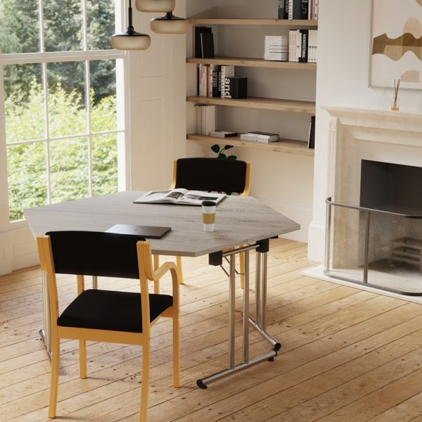 trapezium folding meeting table in grey oak with black fabric conference chair in office