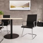 visitor chair with black leather seat and chrome cantilever frame around meeting table