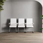 Italian style visitor chair in white leather and chrome cantilever frame. In a row of 3