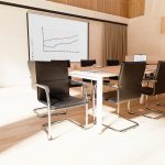 visitor chair black leather around a meeting table
