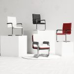 visitor chairs in red, black and white on podium. Showing how they stack