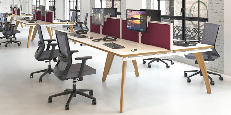 open plan office with contemporary bench desks and grey mesh office chairs