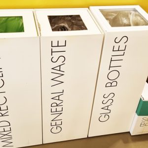 Bins for new waste management rules. white office recycling bins 3 in a row to separate waste streams