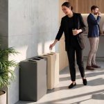 office recycling bin in reception with lady putting waste in the bin
