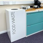 office recycling bin food waste. White bin with black Food Waste lettering in kitchen