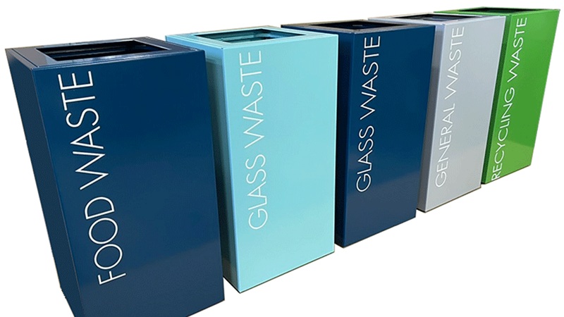 office recycling bins in a row in different colours