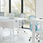mesh back operator chairs in blue, red and grey in open office with white office desks