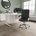 black executive office chair in home office in front of white office desk