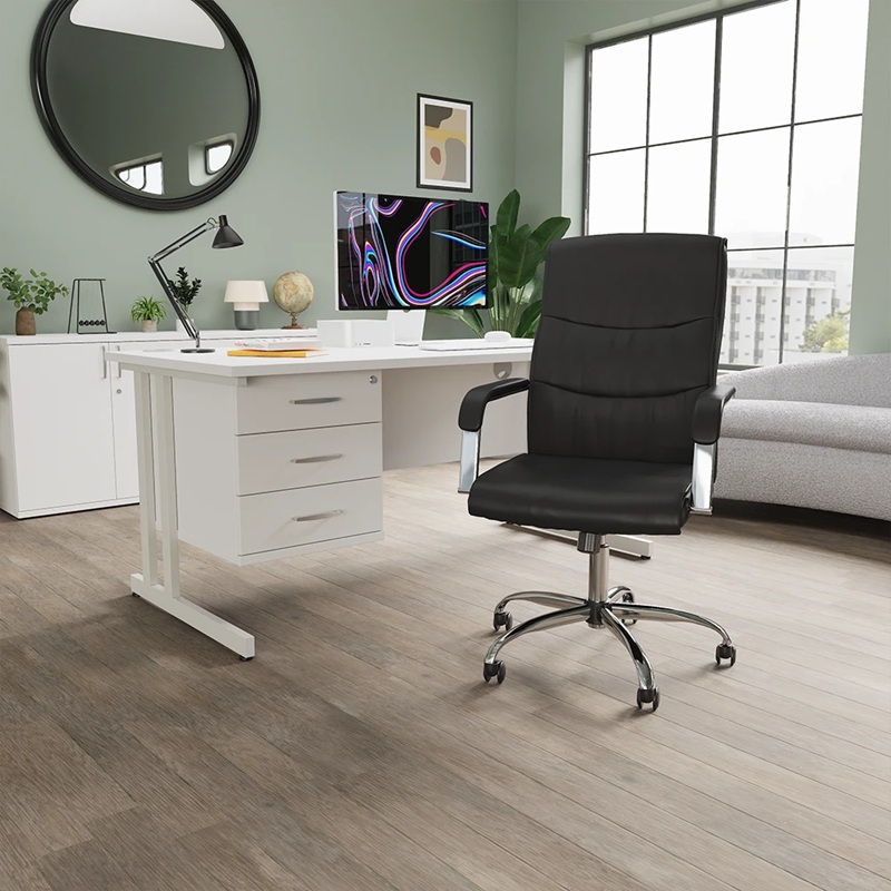 black executive office chair in home office in front of white office desk