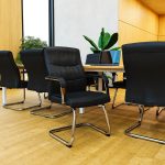 cantilever office visitor chair with chrome frame around meeting table