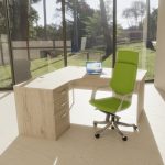 executive office chair in green fabric in home office by office desk with view out to garden