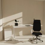 executive office chair in black fabric in front of white office desk