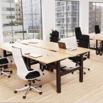 executive high back office chair in black fabric around office desks