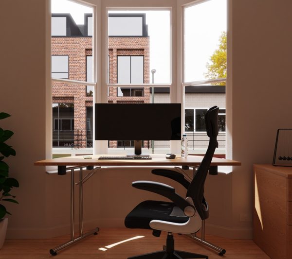 mesh back office chair black in front of desk in window of london flat