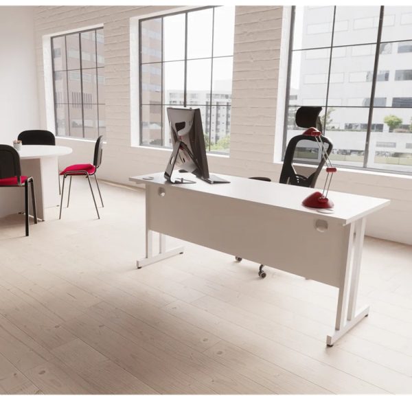 executive mesh chair behind office desk with meeting table