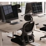 mesh back task operator chairs around a grey oak office desk