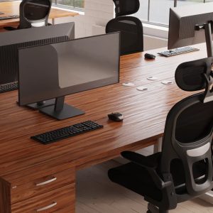 mesh back task operator chair in front of a walnut desk