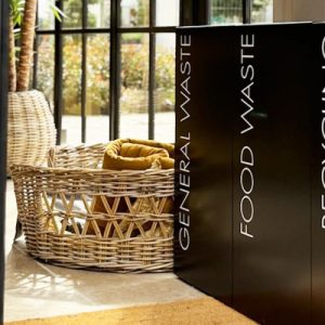 office recycling bins for public areas black in a row of 3 with white lettering