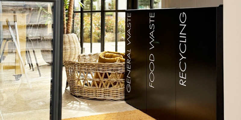 office recycling bins for public areas black in a row of 3 with white lettering