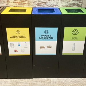 office recycling bins with coloured recycling bin tops in a row with waste stream labelling