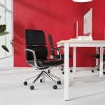 executive office chair in black leather in office with red wall