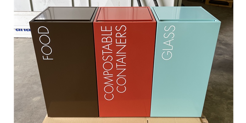 office recycling bins with a lid in a row in different colours and lettering