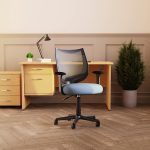 mesh office chair with black mesh back and blue fabric seat in office in front of office desk