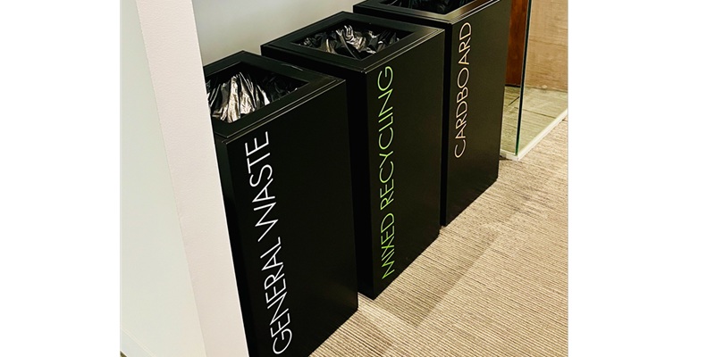office recycling bins online in a row of 3. Black bins with lettering