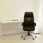 executive office chair black by office desk