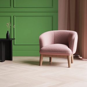 fabric accent chair ideal for receptions in pink fabric with green wall behind