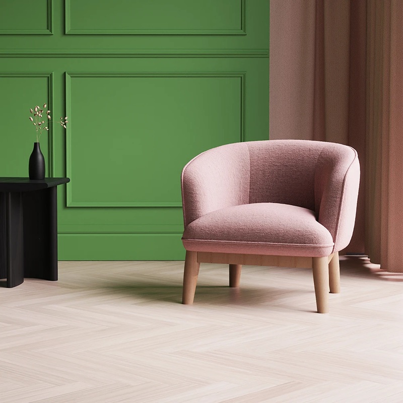 fabric accent chair ideal for receptions in pink fabric with green wall behind