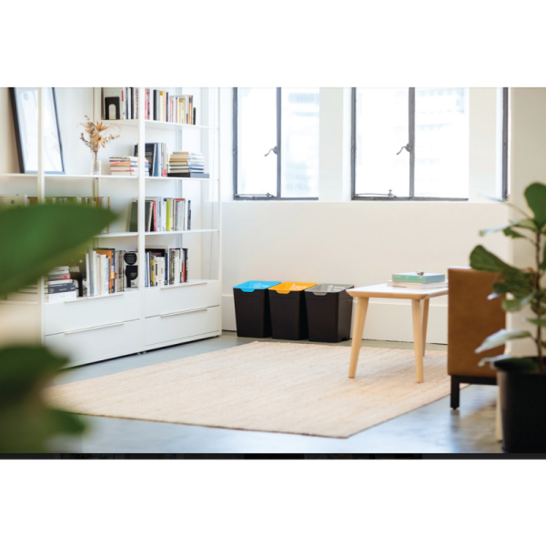 office setting with bookcase and sofa and 3 office recycling waste bins